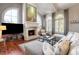 Spacious living room with a fireplace, large windows and hardwood floors at 1696 Windsor Ne Pkwy, Atlanta, GA 30319