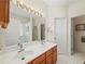 Double vanity bathroom with a large mirror and tiled floor at 1843 Riverton Dr, Suwanee, GA 30024