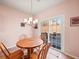 Bright breakfast nook with sliding doors leading to the patio at 1843 Riverton Dr, Suwanee, GA 30024