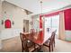 Well-lit dining room with red accent wall and wood table at 1843 Riverton Dr, Suwanee, GA 30024