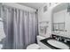 Clean bathroom with gray shower curtain and black countertop at 3894 Foxford Dr, Atlanta, GA 30340