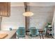 Mid-century modern dining area with wood table, teal chairs, and a unique light fixture at 3894 Foxford Dr, Atlanta, GA 30340