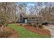 A-frame home with unique exterior, landscaped yard, and carport at 3894 Foxford Dr, Atlanta, GA 30340