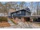 Mid-century modern home with brick and wood siding, carport and landscaping at 3894 Foxford Dr, Atlanta, GA 30340