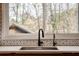 Modern kitchen sink and faucet with geometric tile backsplash at 3894 Foxford Dr, Atlanta, GA 30340