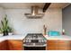 Stainless steel range and geometric backsplash in modern kitchen at 3894 Foxford Dr, Atlanta, GA 30340