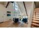 Living room with hardwood floors, a loft, and a view into the kitchen at 3894 Foxford Dr, Atlanta, GA 30340