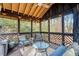 Relaxing screened porch with seating area and wood floors at 3894 Foxford Dr, Atlanta, GA 30340