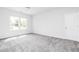 Bright bedroom with grey carpet and two windows at 412 Newland Way, Acworth, GA 30102