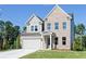 Two-story brick home with gray siding, attached garage, and landscaped lawn at 412 Newland Way, Acworth, GA 30102