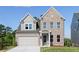 Two-story brick home with gray siding, attached garage, and landscaped lawn at 412 Newland Way, Acworth, GA 30102