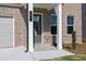 Gray front door with white columns and brick exterior at 412 Newland Way, Acworth, GA 30102