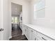 Bright kitchen features white cabinets and a view into the dining area at 412 Newland Way, Acworth, GA 30102