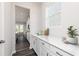 White kitchen cabinets, quartz countertops and view into the living area at 412 Newland Way, Acworth, GA 30102