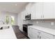 Modern kitchen with white cabinets, stainless steel appliances, and gray tile backsplash at 412 Newland Way, Acworth, GA 30102