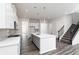 Modern kitchen with white cabinets, large island, and gray tile at 412 Newland Way, Acworth, GA 30102