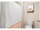 Clean bathroom with shower stall, toilet, and decorative art at 4568 Mantova Dr, Buford, GA 30519