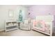 Adorable Bedroom with crib, changing table, and comfortable chair at 4568 Mantova Dr, Buford, GA 30519