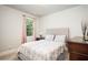 Cozy bedroom with neutral decor, a comfortable bed and ample natural light at 4568 Mantova Dr, Buford, GA 30519