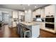 Modern kitchen with white cabinets, granite island and stainless steel appliances at 4568 Mantova Dr, Buford, GA 30519