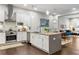 Open concept kitchen with white cabinets, stainless steel appliances and an island at 1388 La France Ne St # 10, Atlanta, GA 30307