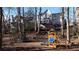 Large backyard with playset, trampoline, and wooded area at 1495 Gabriel Dr, Lawrenceville, GA 30043