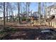 Landscaped backyard with playset and wooded area at 1495 Gabriel Dr, Lawrenceville, GA 30043
