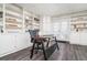 Bright home office with built-in shelving and glass desk, near sliding doors at 1495 Gabriel Dr, Lawrenceville, GA 30043