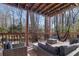 Covered deck with hammock and furniture, wooded view at 1495 Gabriel Dr, Lawrenceville, GA 30043