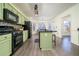Kitchen with green cabinets, black appliances, and island at 1495 Gabriel Dr, Lawrenceville, GA 30043