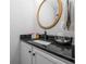 Modern powder room with dark granite countertop and a sleek sink at 1495 Gabriel Dr, Lawrenceville, GA 30043