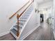 Modern staircase with gray steps and wood railing at 1495 Gabriel Dr, Lawrenceville, GA 30043