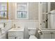 Charming bathroom with floral wallpaper and stained glass window at 407 Bass Se St, Atlanta, GA 30315