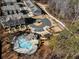 Aerial view of townhomes, parking, pool, and playground offering a modern community lifestyle at 124 Everley Walk, Alpharetta, GA 30009