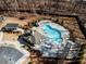 Aerial view of a neighborhood pool, clubhouse, and wooded perimeter at 124 Everley Walk, Alpharetta, GA 30009