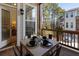 Inviting balcony with outdoor dining setup and a view of the surrounding greenery and neighboring buildings at 124 Everley Walk, Alpharetta, GA 30009