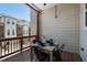 Relaxing balcony with a dining table set for four, offering a private outdoor space with neighborhood views at 124 Everley Walk, Alpharetta, GA 30009
