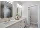 Bright bathroom featuring a dual sink vanity, gold fixtures, and a decorative vase at 124 Everley Walk, Alpharetta, GA 30009
