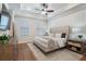 Serene bedroom featuring a plush bed, tray ceiling, ample natural light, and stylish decor for ultimate relaxation at 124 Everley Walk, Alpharetta, GA 30009