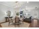 Open concept dining room with seating for four, adjacent to living room and fireplace at 124 Everley Walk, Alpharetta, GA 30009