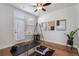 Exercise room featuring wood floors, a ceiling fan, and lots of natural light from the door at 124 Everley Walk, Alpharetta, GA 30009