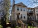 Inviting townhouse features a brick facade, multi-pane windows, and a charming entrance with elevated front yard at 124 Everley Walk, Alpharetta, GA 30009