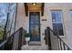 Inviting front door entrance to a townhome with brick exterior at 124 Everley Walk, Alpharetta, GA 30009