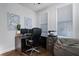 Home office with hardwood floors, L-shaped desk and chair at 124 Everley Walk, Alpharetta, GA 30009