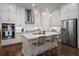 Modern kitchen with white cabinets, stainless steel appliances, and large island at 124 Everley Walk, Alpharetta, GA 30009