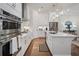 Beautiful kitchen with white cabinetry, stainless steel appliances, a central island, and an open layout at 124 Everley Walk, Alpharetta, GA 30009