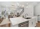 Open-concept kitchen featuring a central island with seating and a view of the adjacent dining and living areas at 124 Everley Walk, Alpharetta, GA 30009
