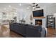 Spacious living room with fireplace, flat screen TV, hardwood floors, and an open layout with adjacent kitchen at 124 Everley Walk, Alpharetta, GA 30009