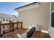 Wooden patio with neutral siding and two white plastic chairs with cushions at 124 Everley Walk, Alpharetta, GA 30009