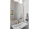 Classic powder room with a pedestal sink, gold mirror and neutral walls, offering a clean and elegant design at 124 Everley Walk, Alpharetta, GA 30009
